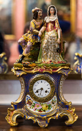 An antique clock ornate with figures and floral motivesの写真素材