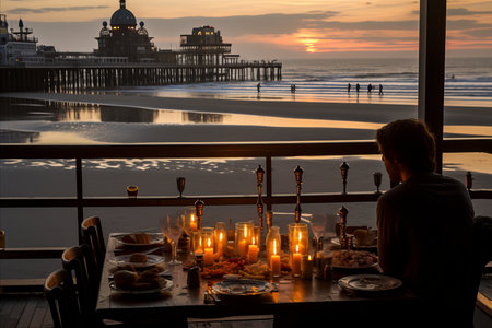 Silhouette of woman sitting at the table and looking at sunset on the pier.の素材