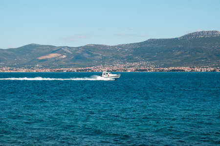 Croatian police speedboat cruising in the open sea near Split, Croatiaの写真素材