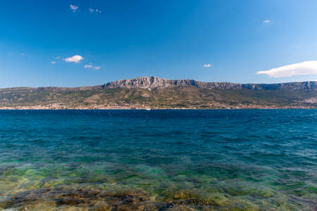 Several towns in the distance, part of Kastela group of towns. Seen from far away from Split. Bright...