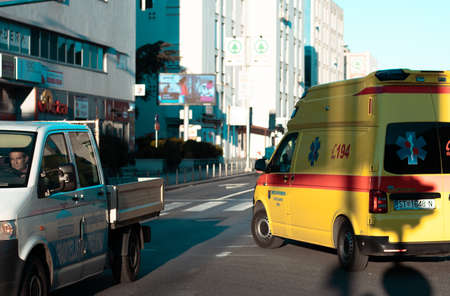 Yellow ambulance taking a left turn on an intersection, going back to hospital in Split during coronavirus outbreak pandemicのeditorial素材