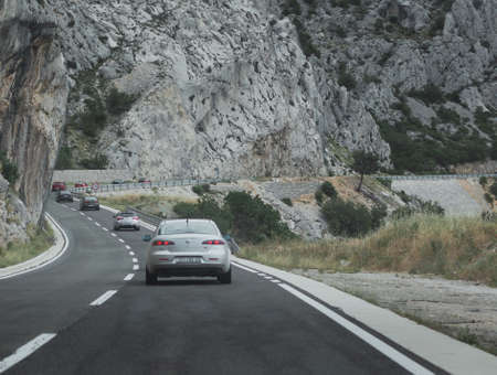 Multiple Alfa Romeos in perfect line driving together as a part of an enthusiast event in Croatia....
