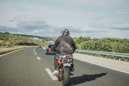Split, Croatia June 2020 Driver on Yamaha Fazer motorbike, white and red Abarth edition seen from...