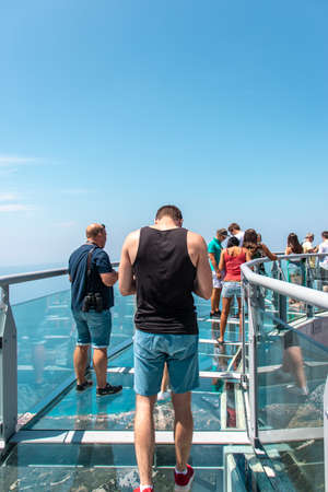 Tourists walking accross the newly built skywalk on Biokovo mountain. Vertical shot seen from the glass structureのeditorial素材