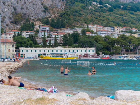 Omis Croatia August 2020 Popular beach in the town of Omis filled with people enjoying a summer day at the beach during the corona virus covid outbreak. Crowded on a late weekend afternoonのeditorial素材