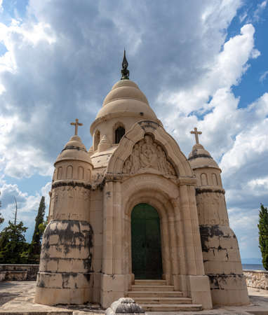 Old historical mauseleum in the cemetary of town of supetar, croatia. Large stone grave dedicated to petrinovic familyのeditorial素材