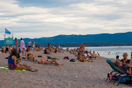 Bol Croatia, August 2020 Famous Zlatni Rat beach filled with tourists and travellers enjoying a warm summer day during the covid global pandemic outbreakのeditorial素材