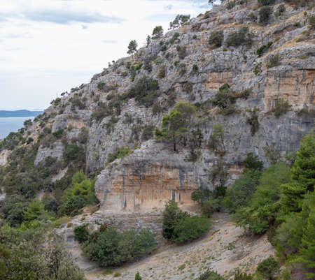 Cliffs surrounding the Pustinja Blaca, deserted remote area on the island of Brac in Croatiaの写真素材