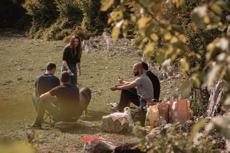 Split Croatia October 2020 A group of friends sitting in the nature in a green field of Rajcica wells, enjoying a warm autumn day. Prepairing to have a barbecue in the forestのeditorial素材