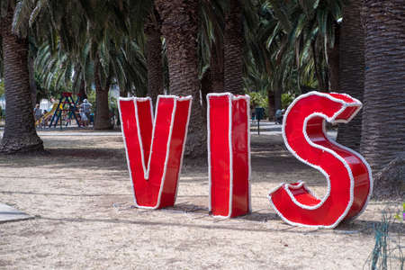 Vis, Croatia July 2021. City of Vis on the island of the same name. Big red letters in the harbour showcasing the tiny cityの写真素材