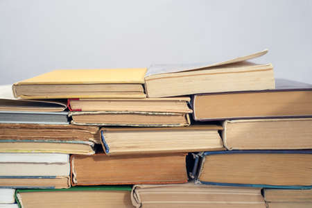 Old books on a light wall background