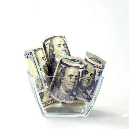 Dollar bills in a glass vase