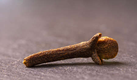 Cloves (Syzygium aromaticum) on a black board, macro photo