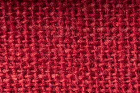 Rough fabric from woven red threads, closeup