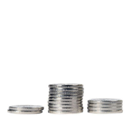 Three piles with coins on a white background.の写真素材