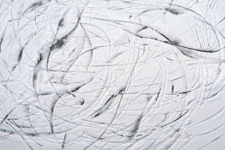 Skate tracks on snow and ice top view.