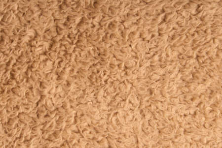 Brown shaggy blanket texture as background top view.