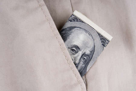 a hundred dollars peeking out from pocket.