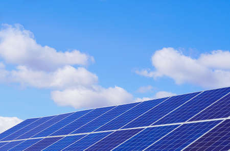clear sky with white clouds and solar panels.