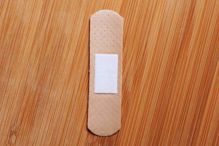 medical plaster or patch on wooden background.の写真素材