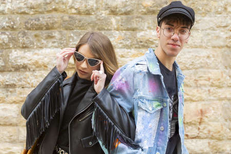 Young couple has fun walking through the narrow medieval streets of a country in southern Italyの写真素材