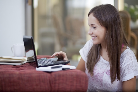 Young happy woman working in her living roomの写真素材