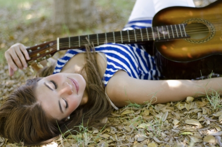 Pretty young woman relaxing and finding some inspiration at a parkの写真素材