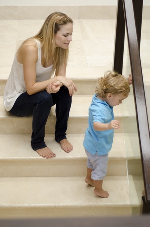 Young mother and her son spending some time together at homeの写真素材