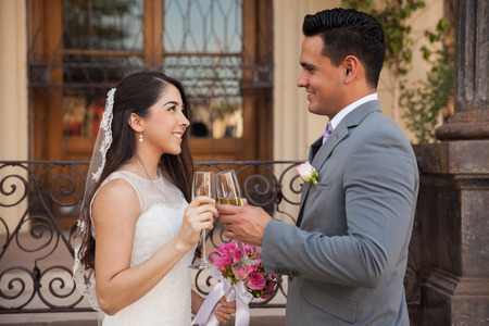 Romantic couple making a toast with champagne on their wedding dayの写真素材