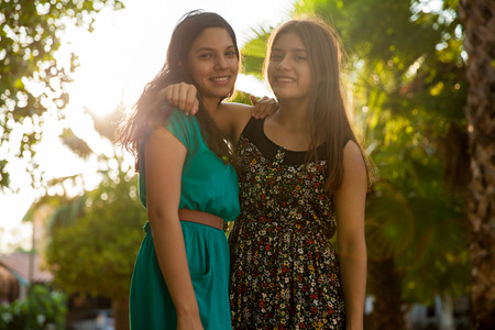 Beautiful teenage girls hanging out at a park on a sunny dayの写真素材