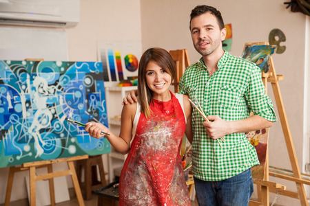 Portrait of a cute young Latin couple visiting an art school together and having some funの写真素材