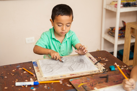 Portrait of a little boy working on a drawing for his art class at schoolの写真素材