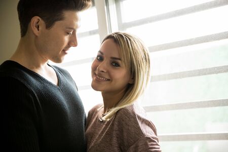 Backlit portrait of a gorgeous young Latin woman spending time with her boyfriend and smiling