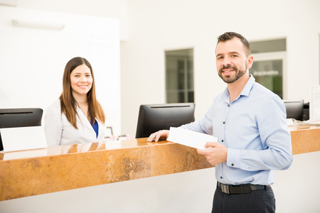 Portrait of a handsome Hispanic man receiving his test results in a laboratoryの写真素材