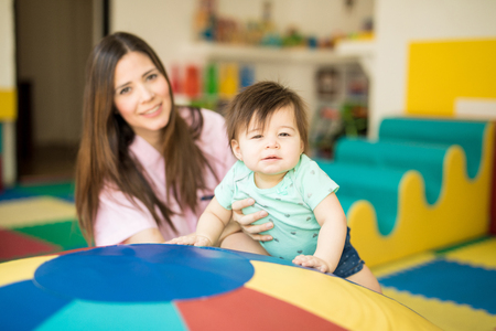 Cute baby and her therapist getting some early stimulation exercises in a special schoolの写真素材