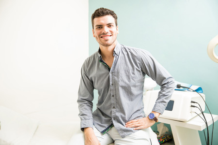 Attractive young man visiting his regular spa and ready to relax and get a massageの写真素材