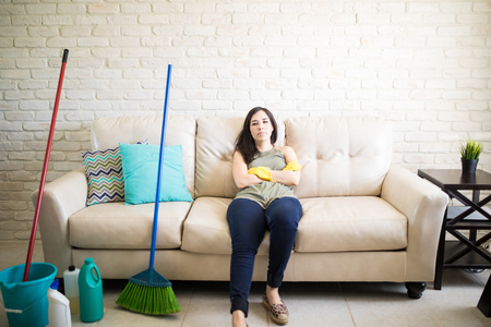 Exhausted woman resting after exhaustive house cleaning dayの写真素材