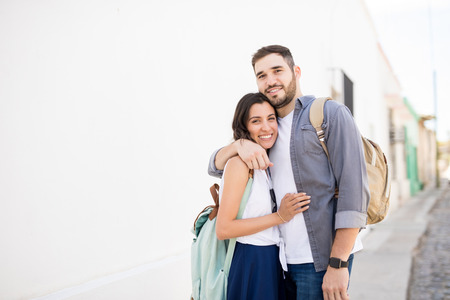 Happy young couple posing together and smiling at camera