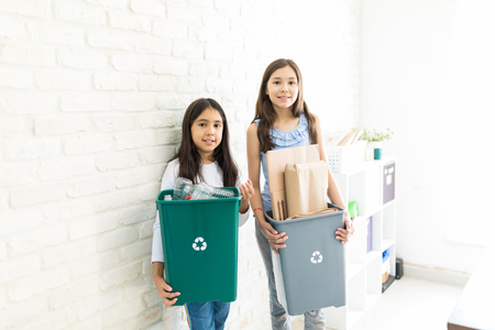 Young girls showing responsibility towards conserving nature at homeの写真素材