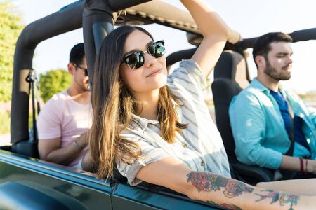 Relaxed woman enjoying road trip with friends in summerの写真素材