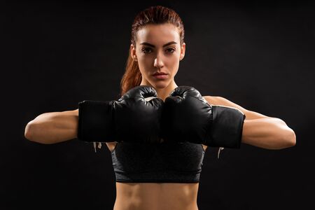 Portrait of Caucasian boxer bumping fists against plain backgroundの写真素材