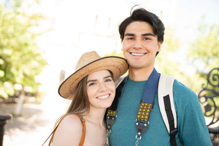 Happy young boyfriend and girlfriend at park during weekendの写真素材