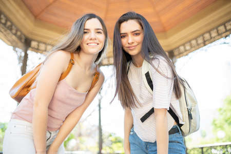 Portrait of smiling beautiful young friends going on a trip together on the weekendの写真素材