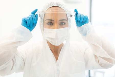 Portrait of female doctor wearing face shield and mask during coronavirus outbreak