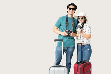 Smiling Latin young boyfriend and girlfriend going on vacation