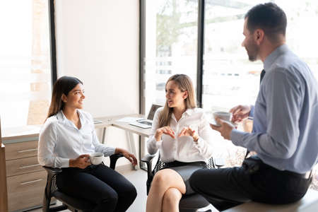 Business team having a casual talk during coffee break at officeの写真素材