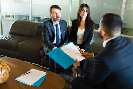 Business partners having a meeting with a businessman in his office. Successful sales...