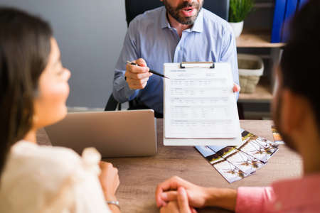 This is your travel itinerary. Close up of a travel agent showing the flight itinerary of a vacation...