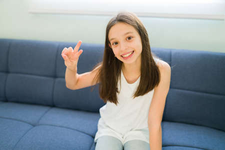 Feeling happy after live streaming my video blog. Portrait of a beautiful caucasian girl smiling and...