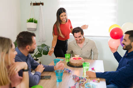 Surprise! Handsome young man feeling thankful and excited for his surprise birthday party. Friends...